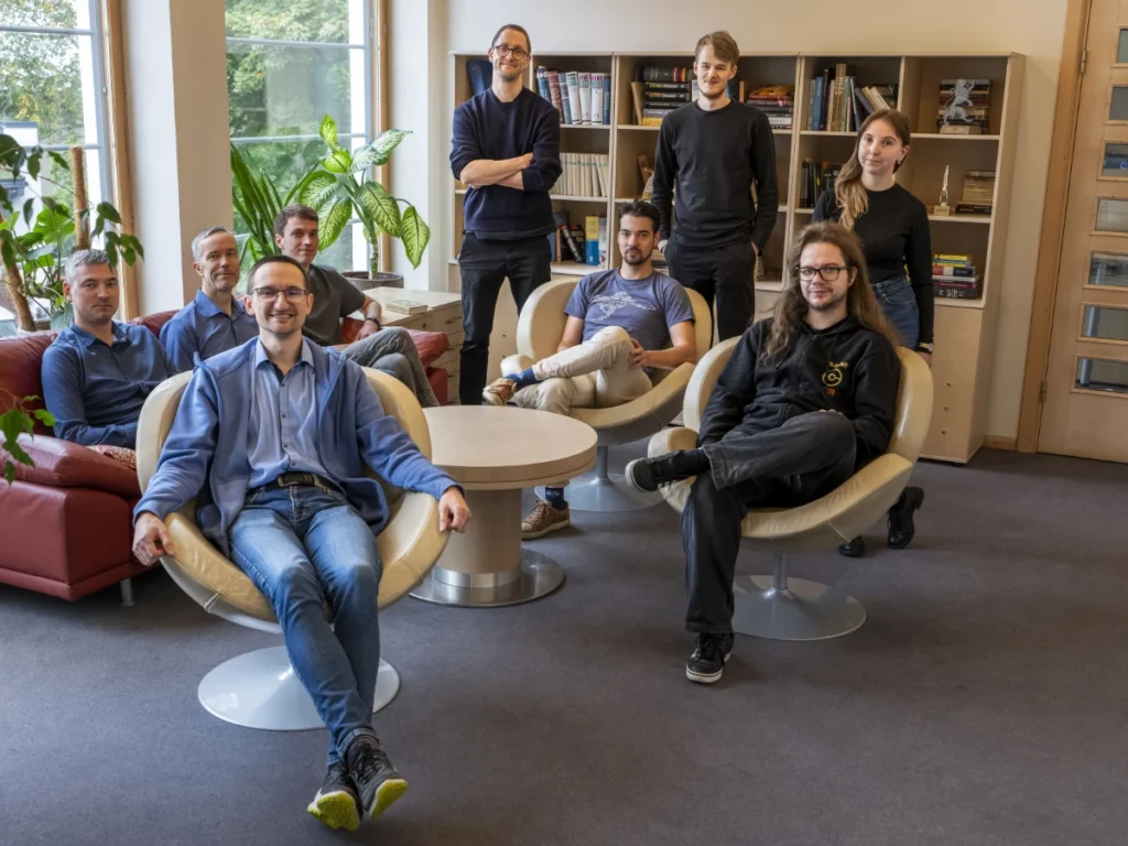 TildeOpen research team members sitting in the office